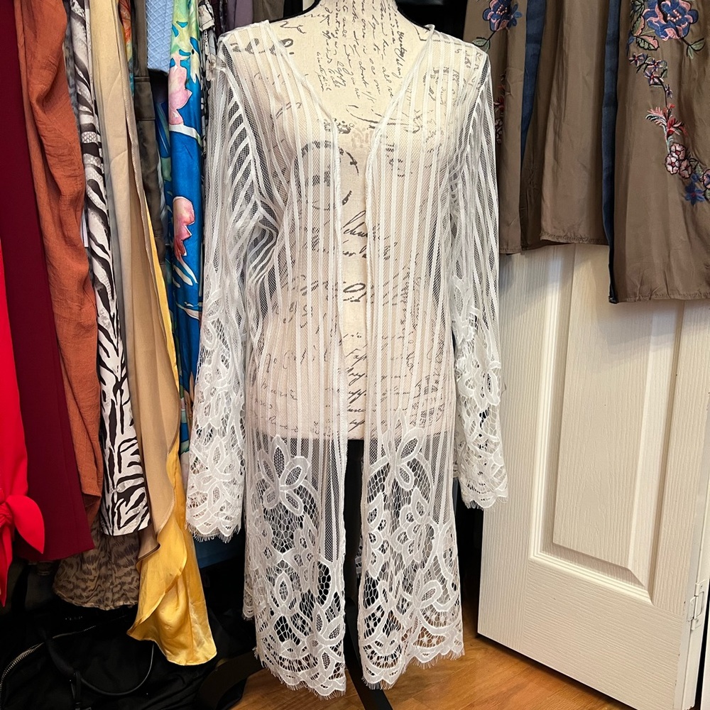 White cover up. Can be worn with jeans or as a bathing suit cover up. Never worn